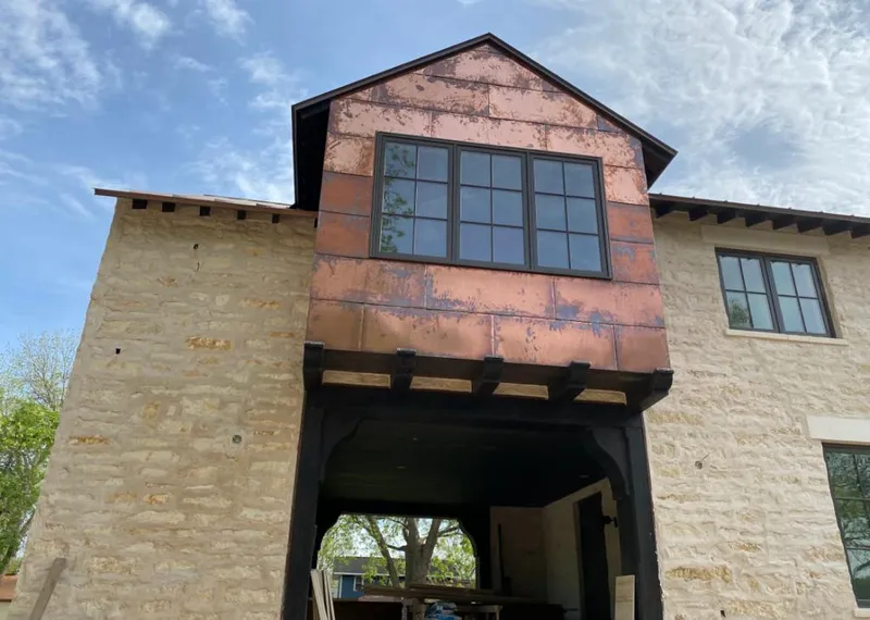 Copper metal panel facade on a stone building for Skylight Installation in Zionsville