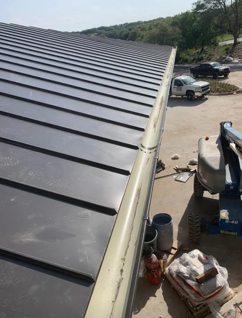 Standing seam panel and gutter detail on a metal roofing jobsite in Zionsville
